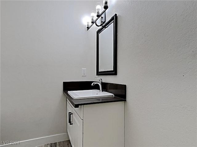 bathroom with vanity and hardwood / wood-style flooring