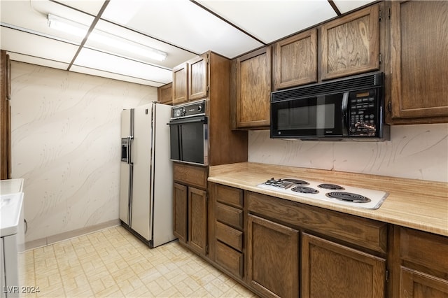 kitchen featuring black appliances and light tile patterned flooring