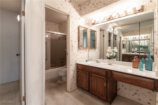 full bathroom featuring shower / bath combination with glass door, toilet, and vanity