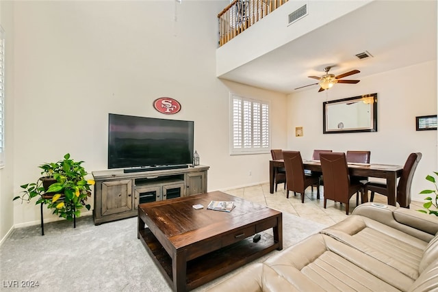 living room with ceiling fan and light tile patterned floors