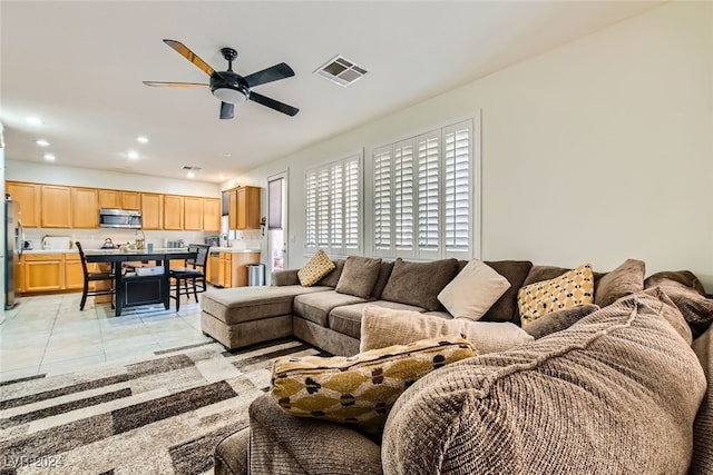 living room featuring ceiling fan and light tile patterned floors