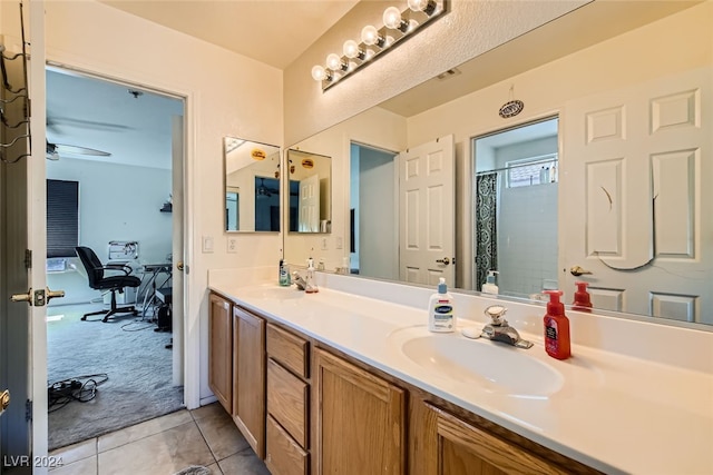 bathroom with ceiling fan, vanity, walk in shower, and tile patterned floors