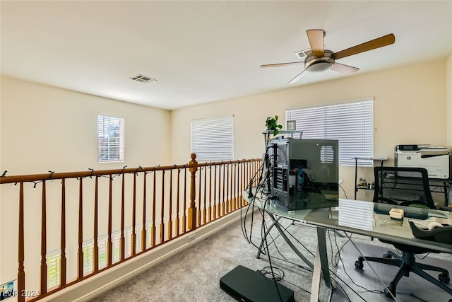 office space with ceiling fan and carpet