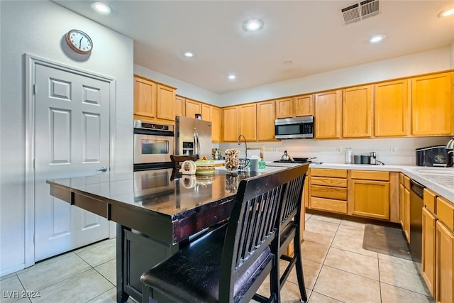 kitchen featuring sink, stainless steel appliances, and light tile patterned floors