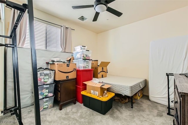 bedroom featuring ceiling fan and light carpet