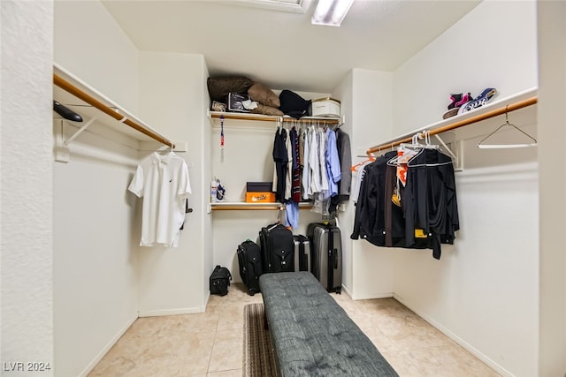 walk in closet featuring light tile patterned flooring