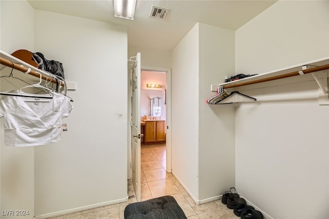 spacious closet with light tile patterned floors