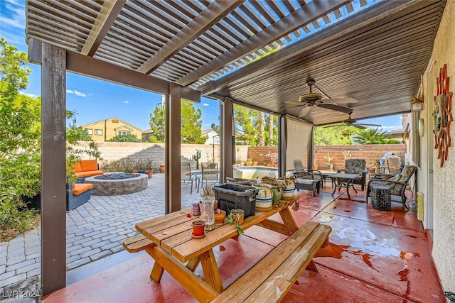 view of patio / terrace with a pergola, ceiling fan, and a fire pit