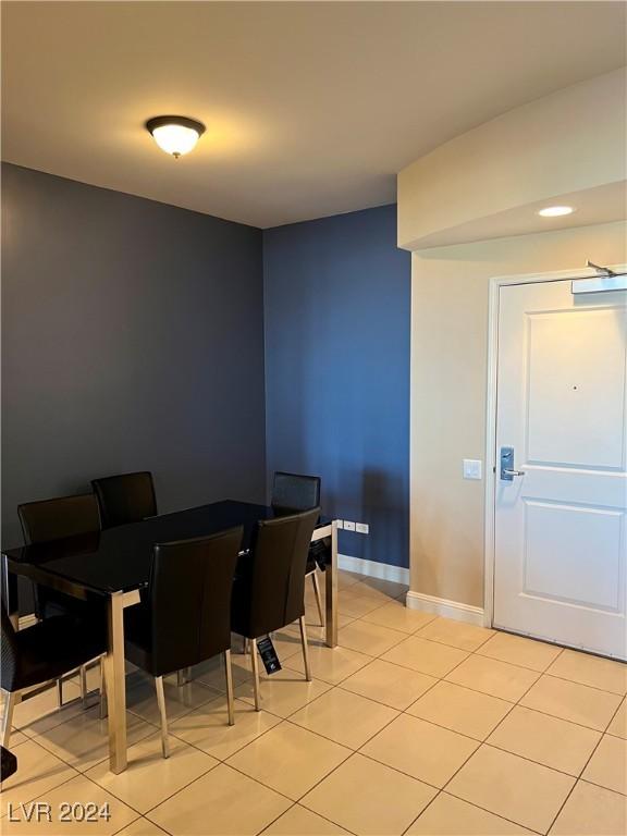 dining space with light tile patterned floors and baseboards