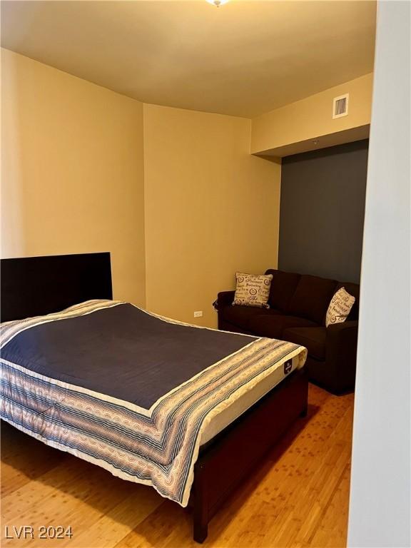 bedroom featuring light wood-style floors and visible vents