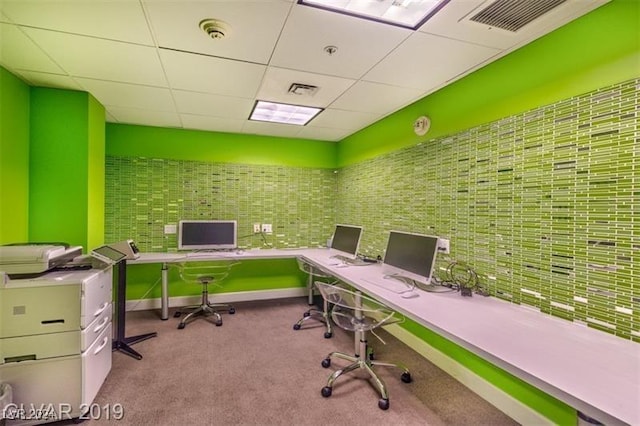 office area with carpet floors, baseboards, visible vents, and a drop ceiling