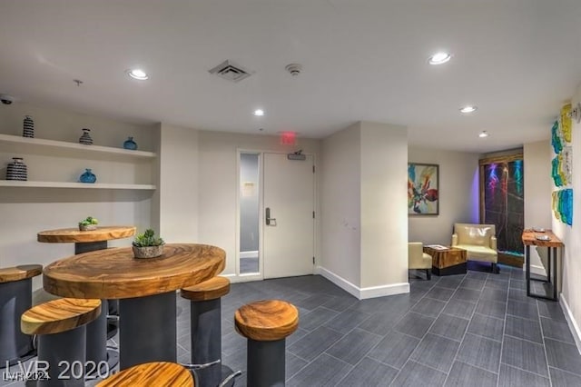 interior space featuring baseboards, visible vents, and recessed lighting