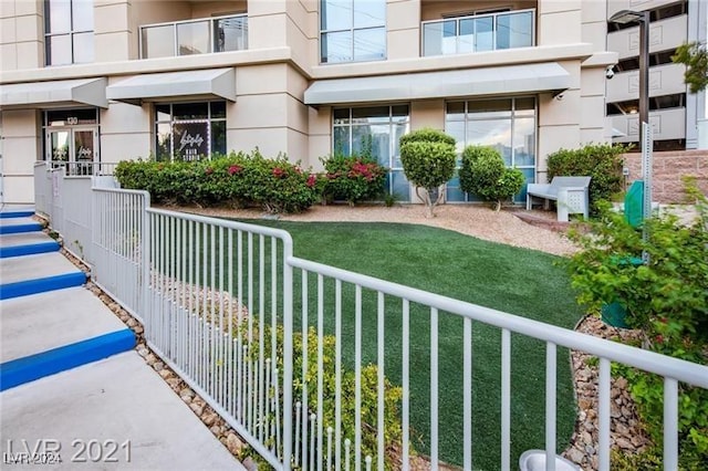 property entrance featuring fence and stucco siding