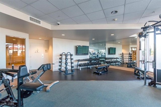 workout area featuring a drop ceiling, visible vents, and recessed lighting