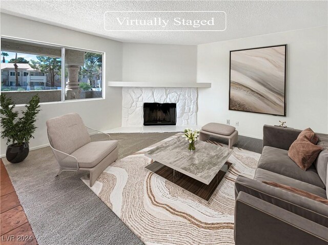 tiled living room with a textured ceiling and a fireplace