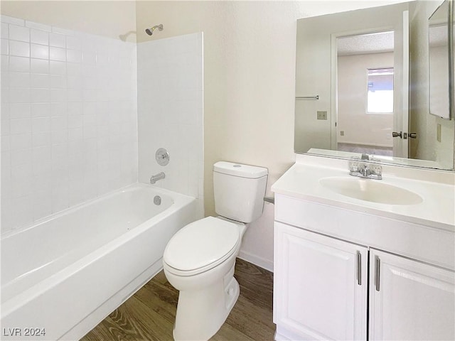 full bathroom with vanity, wood-type flooring, tub / shower combination, and toilet