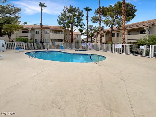 view of pool featuring a hot tub and a patio