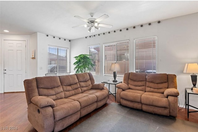 living area featuring recessed lighting, wood finished floors, a ceiling fan, and baseboards