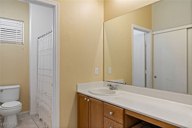 bathroom featuring tile patterned floors, vanity, and toilet