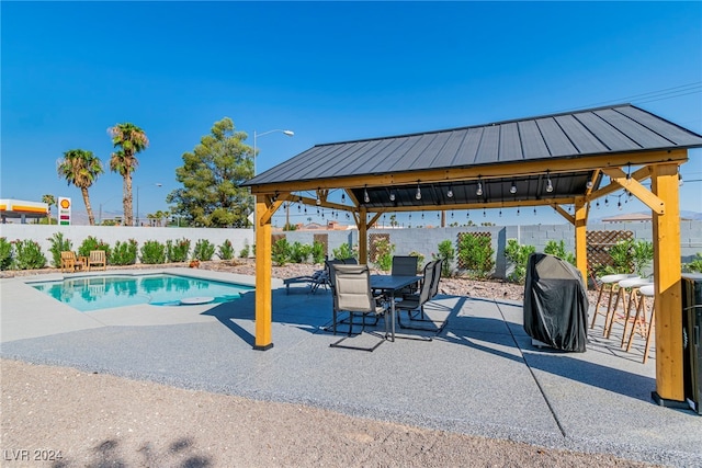 view of pool featuring a patio and a gazebo