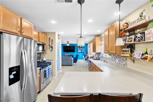 kitchen with kitchen peninsula, hanging light fixtures, light tile patterned flooring, backsplash, and stainless steel appliances