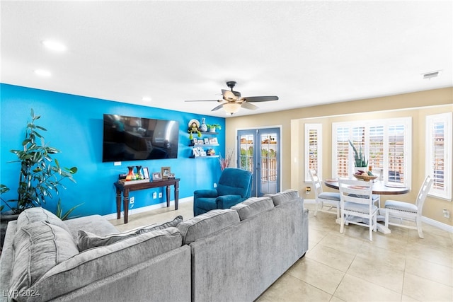 living room featuring french doors, light tile patterned floors, and ceiling fan