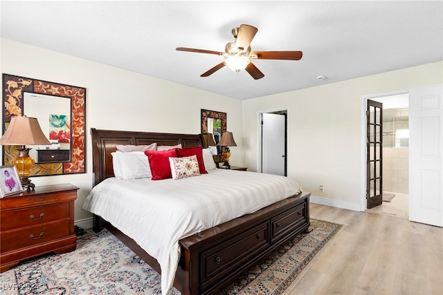 bedroom with ceiling fan, connected bathroom, and light hardwood / wood-style floors