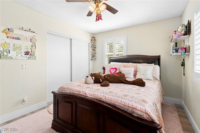 bedroom featuring ceiling fan, a closet, and light hardwood / wood-style floors