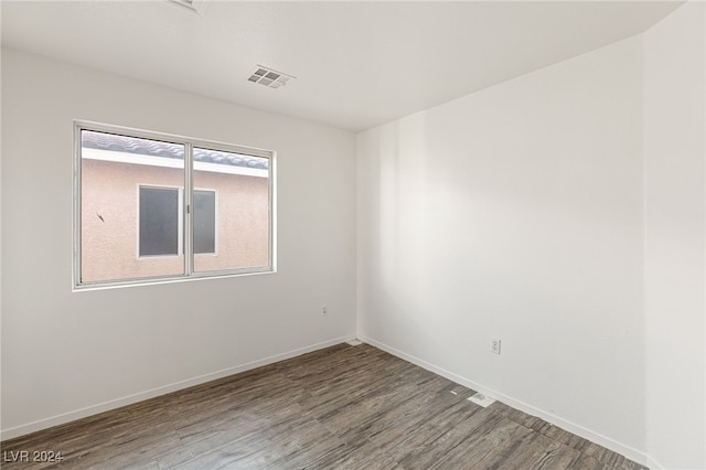 unfurnished room with wood-type flooring