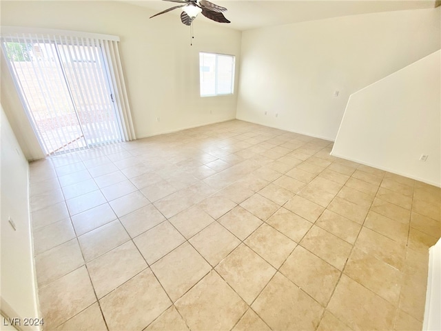 tiled spare room featuring ceiling fan and a healthy amount of sunlight