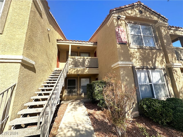 rear view of property with a balcony