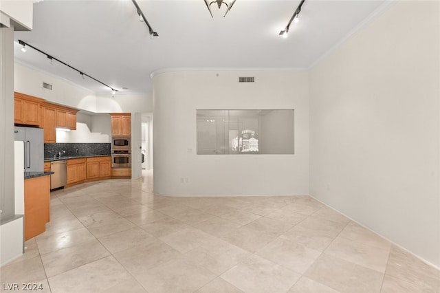 unfurnished living room featuring light tile patterned floors, ornamental molding, and track lighting