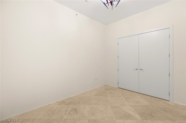 unfurnished bedroom with a closet and light tile patterned floors