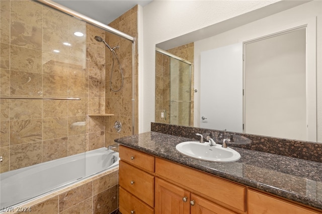 bathroom with combined bath / shower with glass door and vanity