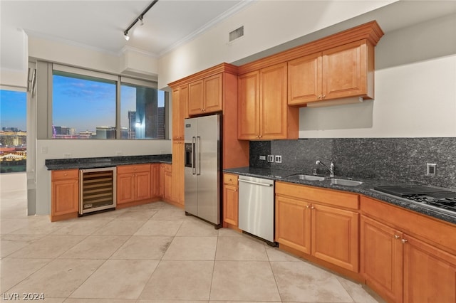 kitchen with track lighting, wine cooler, sink, dark stone countertops, and stainless steel appliances