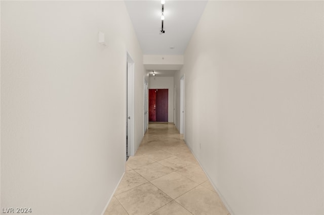 hall with light tile patterned floors