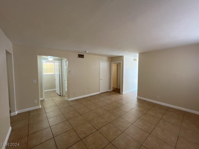 spare room with light tile patterned flooring