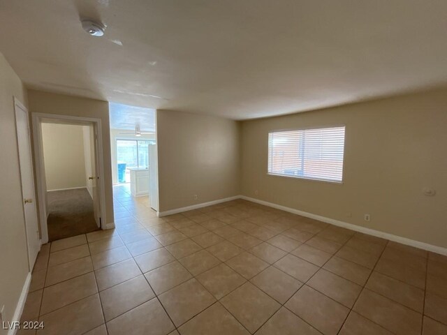 spare room with light tile patterned flooring and plenty of natural light