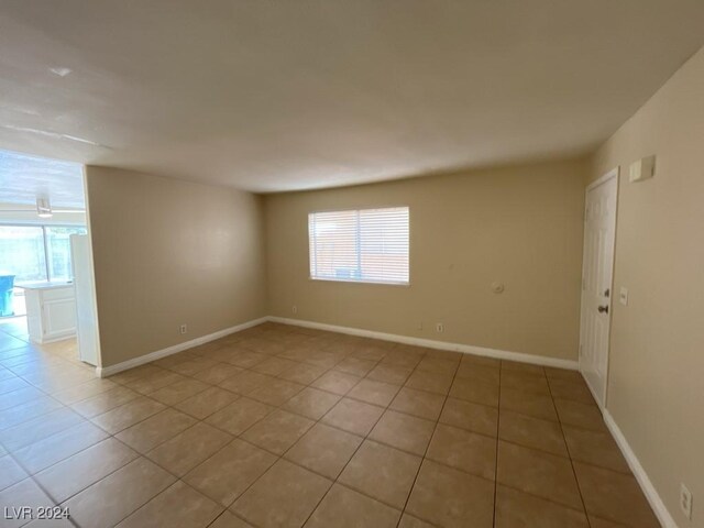 unfurnished room with a wealth of natural light and tile patterned flooring