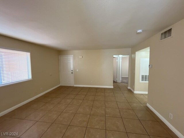 empty room with tile patterned flooring