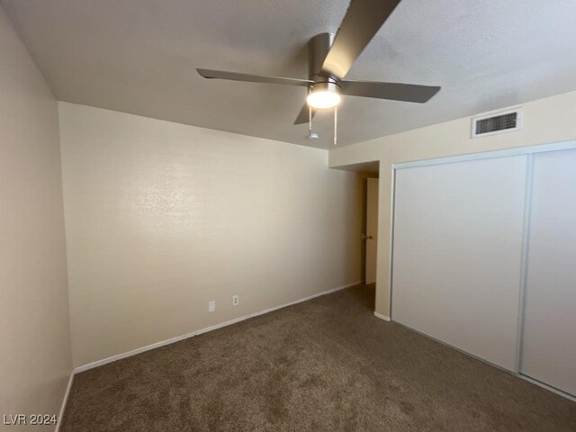 unfurnished bedroom featuring ceiling fan, carpet floors, and a closet