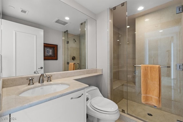 bathroom featuring toilet, an enclosed shower, and vanity