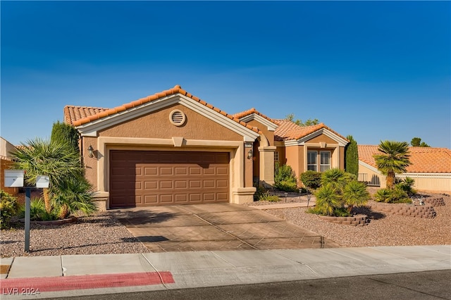 mediterranean / spanish-style house featuring a garage