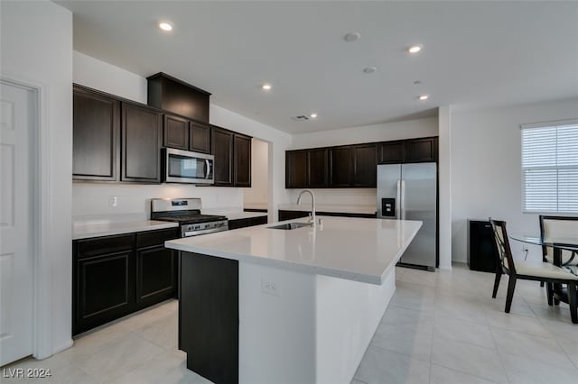 kitchen with a center island with sink, sink, dark brown cabinetry, and stainless steel appliances