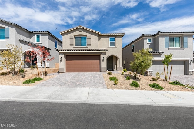 mediterranean / spanish-style home with a garage