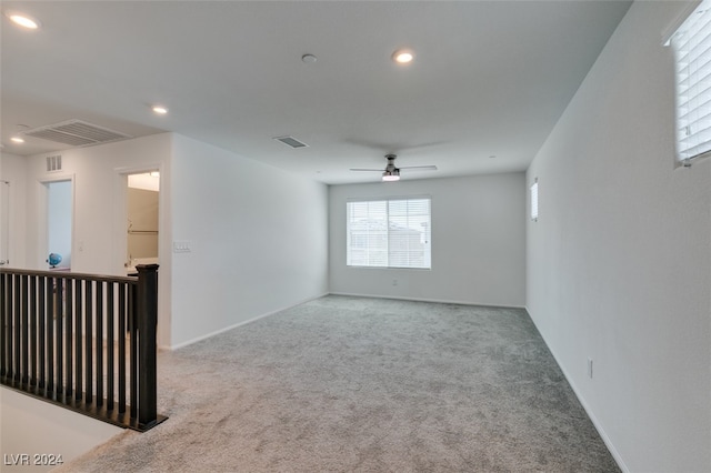 spare room with ceiling fan and carpet floors