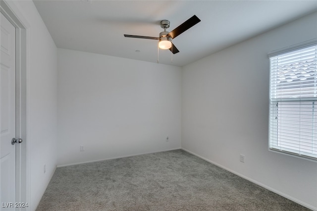 spare room with light carpet and ceiling fan