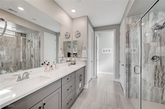 bathroom featuring vanity and an enclosed shower