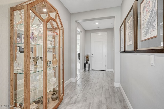 hall with light hardwood / wood-style floors