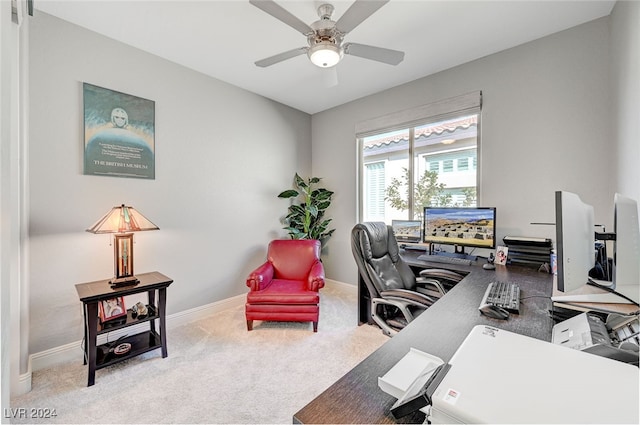 carpeted office space featuring ceiling fan